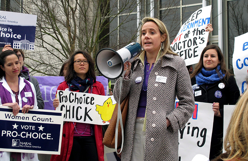 Ellie Schilling, center, a lawyer representing Louisiana abortion clinics, speaks at a protest outside the Department of Health and Hospitals building in Baton Rouge, La. 