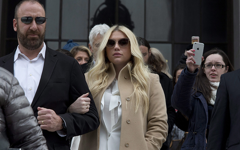 Pop star Kesha, center, leaves Supreme court in New York, Friday, Feb. 19, 2016. Kesha is fighting to wrest her career away from a hitmaker she says drugged, sexually abused and psychologically tormented her - and still has exclusive rights to make records with her. 