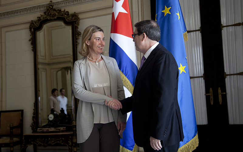 European Union Foreign Policy chief Federica Mogherini shakes hands with Cuban Foreign Minister Bruno Rodriguez, before a meeting, where an agreement was signed to establish normal relations, in Havana, Cuba, Friday, March 11, 2016. 