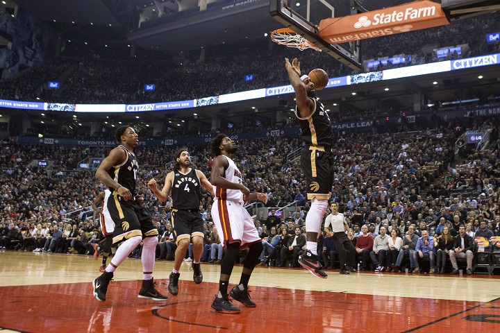 Toronto Raptors' James Johnson scores on the Miami Heat defence during first half NBA basketball action in Toronto on Saturday, March 12, 2016.