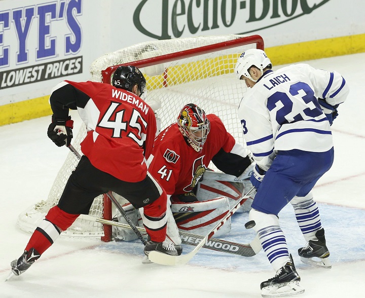 Toronto Maple Leafs' Brooks Laich (23) looks for the loose puck as Ottawa Senators' Chris Wideman (45) and goalie Craig Anderson (41) look on during second period NHL hockey action in Ottawa on Saturday, March 12, 2016.