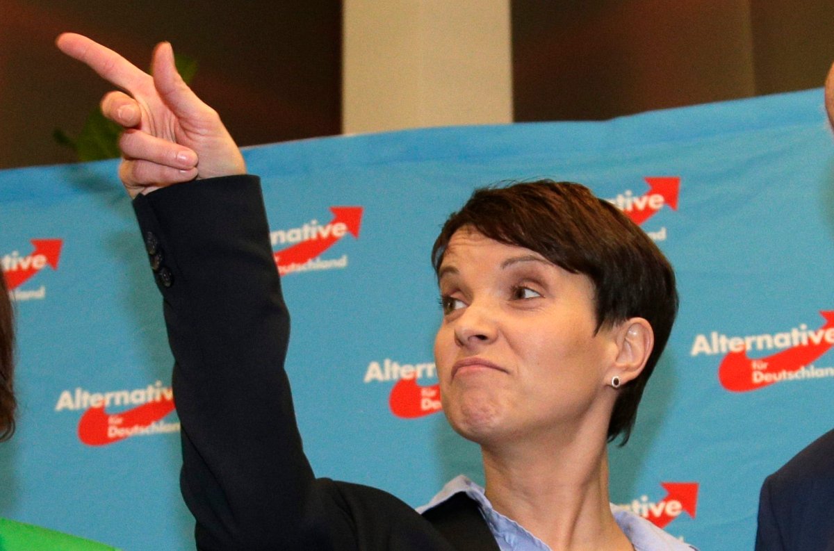 Frauke Petry, chairwoman of the AfD, points her finger at the gathering of the right-populist AfD (Alternative for Germany) after the closing of the state elections in the German federal states of Baden-Wuerttemberg, Rhineland-Palatinate and Saxony-Anhalt in Berlin, Germany, Sunday, March 13, 2016. 