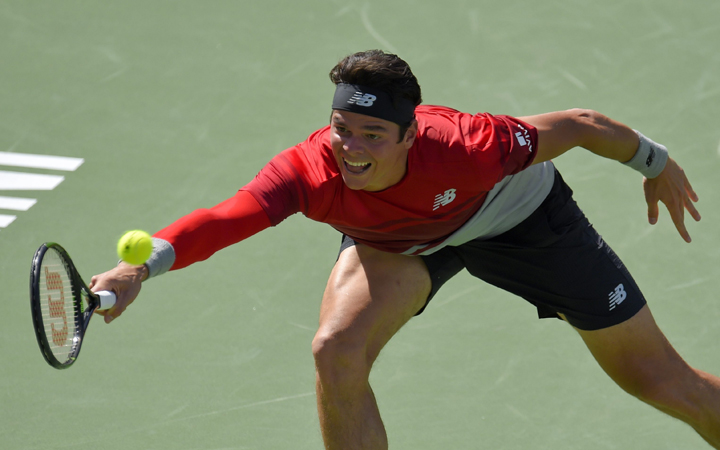 Milos Raonic, of Canada, returns to Novak Djokovic, of Serbia, during a finals match at the BNP Paribas Open tennis tournament, Sunday, March 20, 2016, in Indian Wells, Calif. 