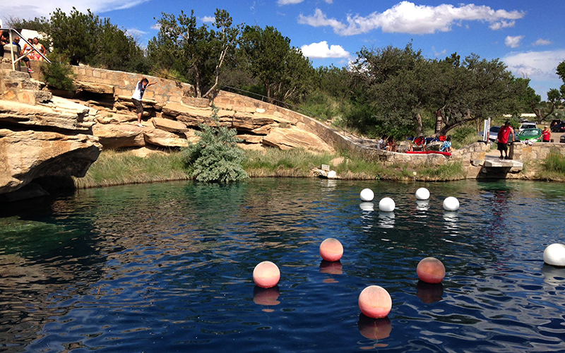 A boy leaping into the water at Blue Hole State Park in Santa Rosa, N.M. An eastern New Mexico police chief says an experienced California diver has died in an underwater cave beneath a swimming hole.  