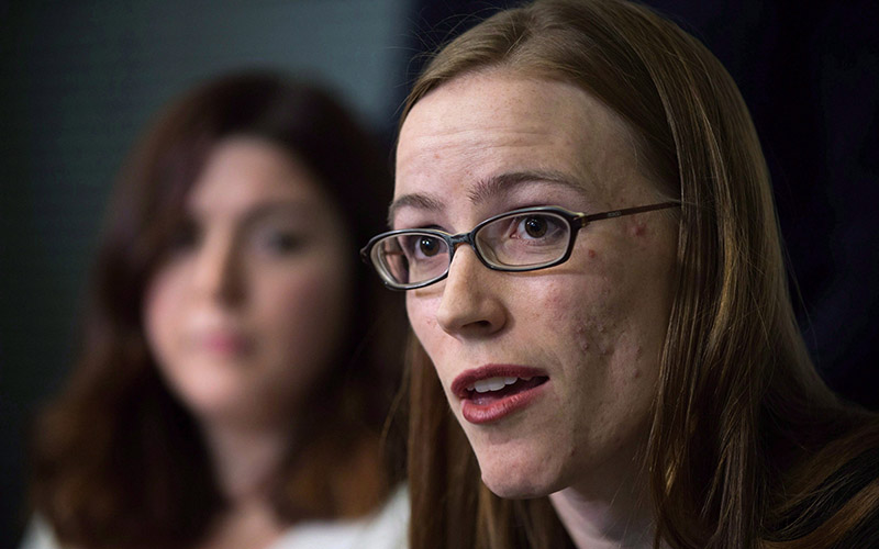 Former University of British Columbia students Glynnis Kirchmeier and Caitlin Cunningham, back, hold a news conference at the university in Vancouver, B.C., on Sunday, November 22, 2015. Kirchmeier has filed a human rights complaint alleging the school discriminated against her and other complainants in its handling of sexual assault reports. 