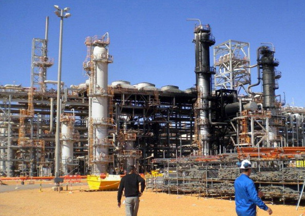 This picture taken on January 31, 2013 shows workers outside a desert gas plant after it opened for the press the first time after dozens of foreigners were killed during a four-day standoff that ended in a bloody showdown with Algerian commandos in In Amenas.