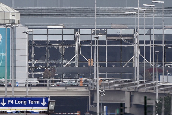 A picture taken on March 22, 2016 in Zaventem, shows the damaged facade of Brussels airport after at least 13 people were killed and 35 injured as twin blasts rocked the main terminal of Brussels airport. 