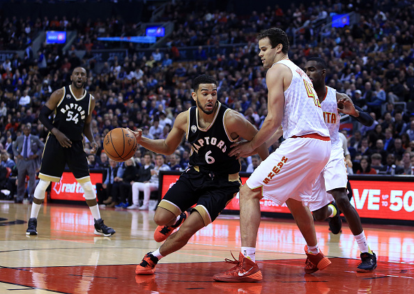 Cory Joseph #6 of the Toronto Raptors dribbles the ball as Kris Humphries #43 of the Atlanta Hawks defends during the first half of an NBA game at the Air Canada Centre on March 30, 2016 in Toronto, Ontario, Canada. (Photo by Vaughn Ridley/Getty Images).