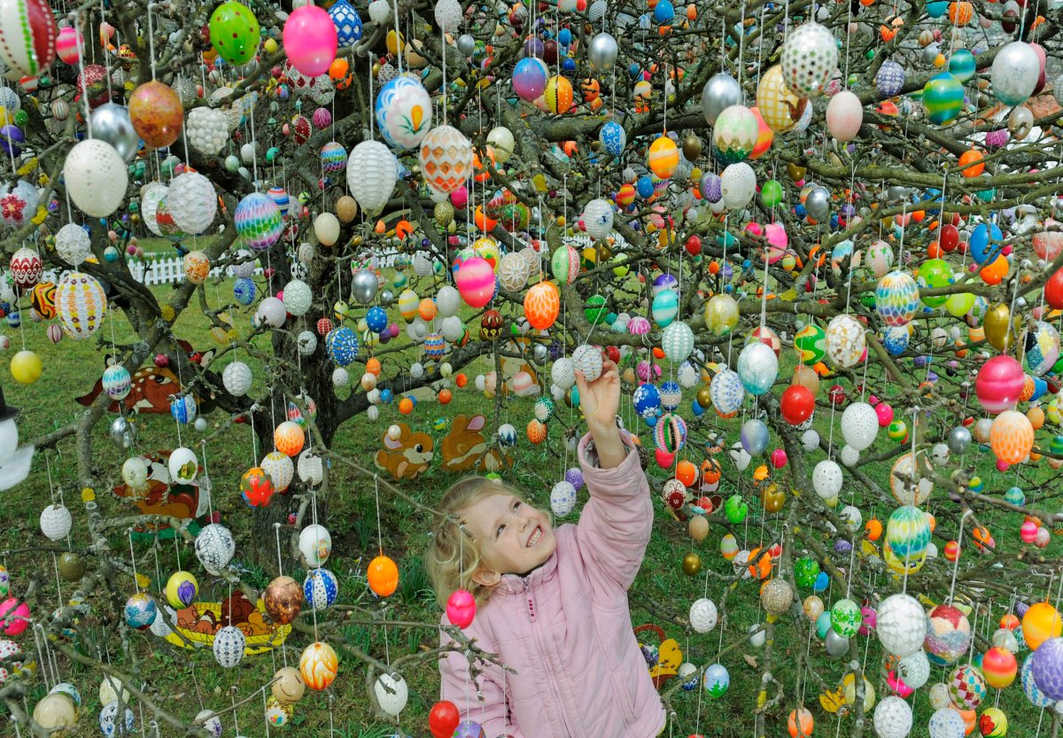 Jette Kuehlwei stands among  around 9,500  Easter eggs in the garden of Christa and Volker Kraft in Saalfeld, Germany, Sunday, March 28, 2010.