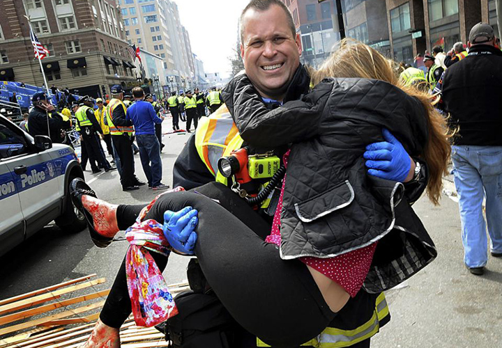 Boston Firefighter James Plourde carries Victoria McGrath from the scene after a bombing near the Boston Marathon finish line.