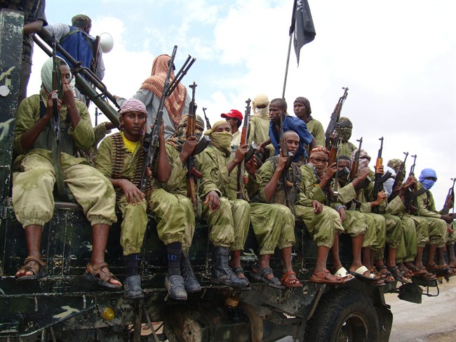 In this Oct. 30, 2009 file photo, al-Shabab fighters sit on a truck as they patrol in Mogadishu, Somalia.  