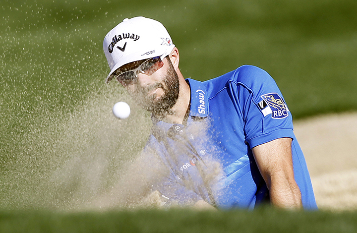 Adam Hadwin hits out of the bunker on the eighth fairway during the final round of the CareerBuilder Challenge golf tournament on the TPC Stadium course at PGA West in La Quinta, Calif., Sunday, Jan. 24, 2016. 