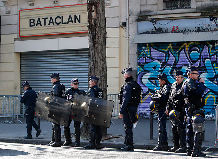 Riot police officers guard the Bataclan concert hall in Paris, Thursday, March 17, 2016. 