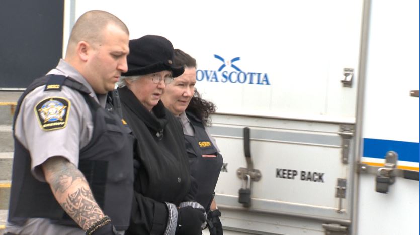 Melissa Ann Shepard, known as the Internet Black Widow, is escorted into Dartmouth provincial court on Tuesday, March 15, 2016. 