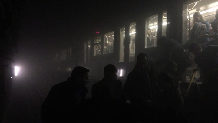 Passengers are evacuated from a subway car after explosions in a station in Brussels.