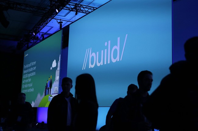 People make their way to their seats for the start of the keynote address of the Microsoft Build Conference, Wednesday, March 30, 2016, in San Francisco. 