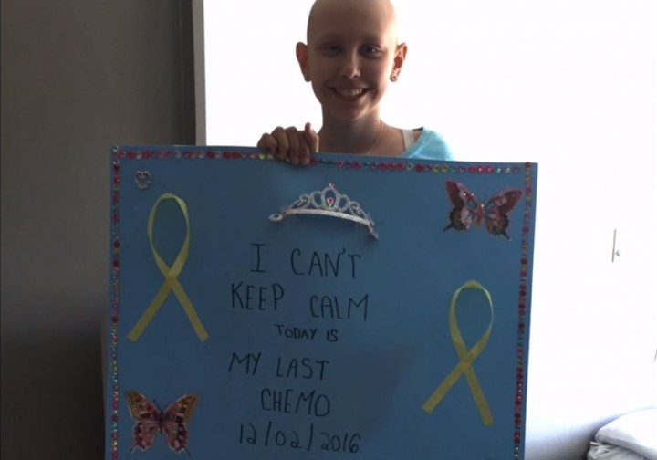 Christina, a young cancer patient at the Montreal Children's Hospital, holds up a sign that says "I can't keep calm, today is my last chemo," Monday, March 1, 2016.