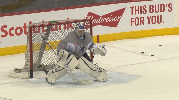 Eric Comrie eyes up a shot during practice with the Manitoba Moose at Bell MTS Place.