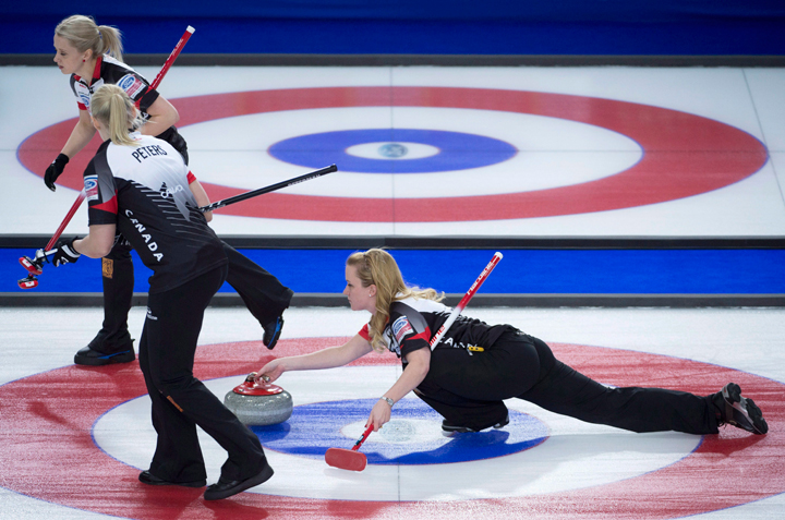 Canada skip Chelsea Carey makes a shot as second Jocelyn Peterman and lead Laine Peters sweep during the 3rd draw against Switzerland at the Women's World Curling Championship in Swift Current, Sask. Sunday, March 20, 2016. Carey is drawing inspiration from her dad Dan, a former Brier champion.