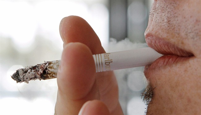 A man smokes a cigarette in Hialeah, Fla., Feb.7, 2011.