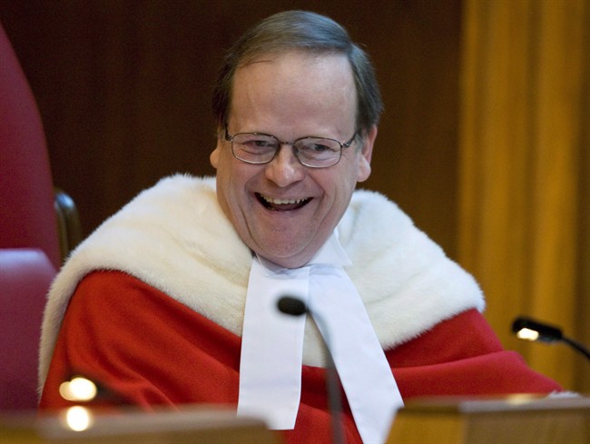 Justice Thomas Cromwell laughs as he listens to speakers during a ceremony officially welcoming him to the Supreme Court of Canada in Ottawa, Monday, Feb. 16, 2009.