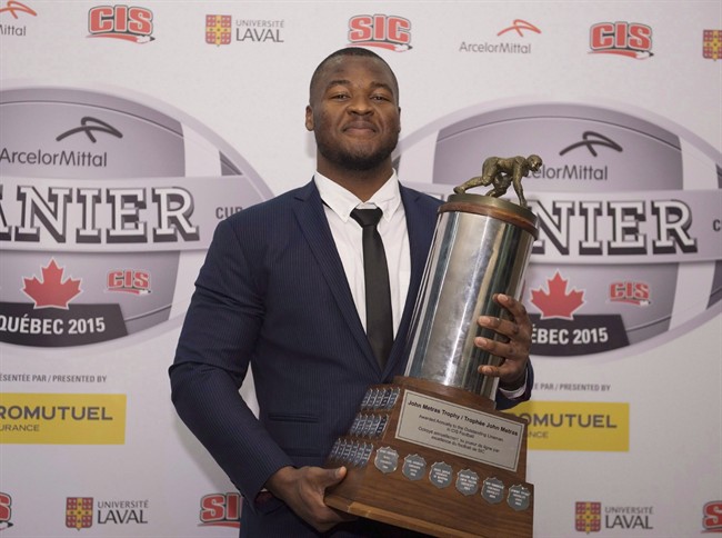 David Onyemata, of the University of Manitoba, holds the J.P. Metras Trophy as the most outstanding down lineman of the year during November's CIS Awards gala.
