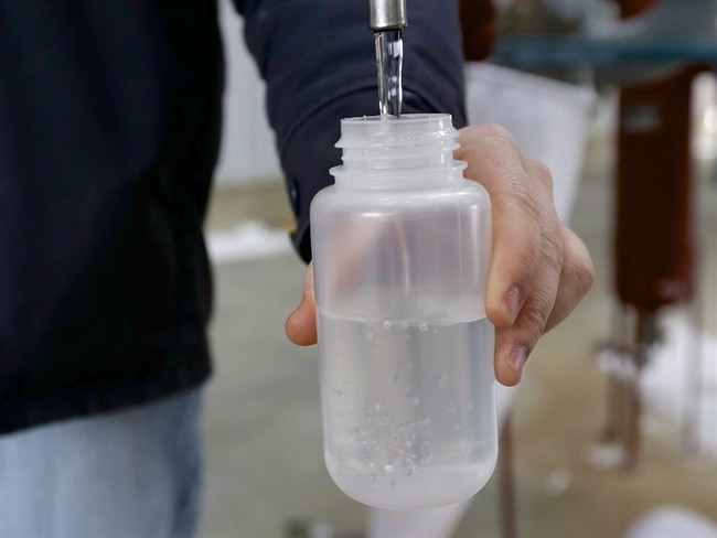 In this photo from Jan. 6, 2015, Ryan Brock fills a sample bottle with ethanol produced at the Green Plains ethanol plant in Shenandoah, Iowa. 