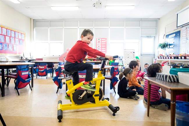 Andrew Tilley, 5, rides a stationary bike during a lesson in teacher Mary Theresa Burt's classroom at Ian Forsyth Elementary School in Dartmouth, N.S. on Monday, March 7, 2016.