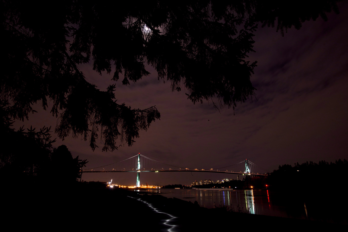 The lights on the Lions Gate bridge are off during Earth Hour as seen from West Vancouver, B.C. Saturday, March, 23, 2013. 