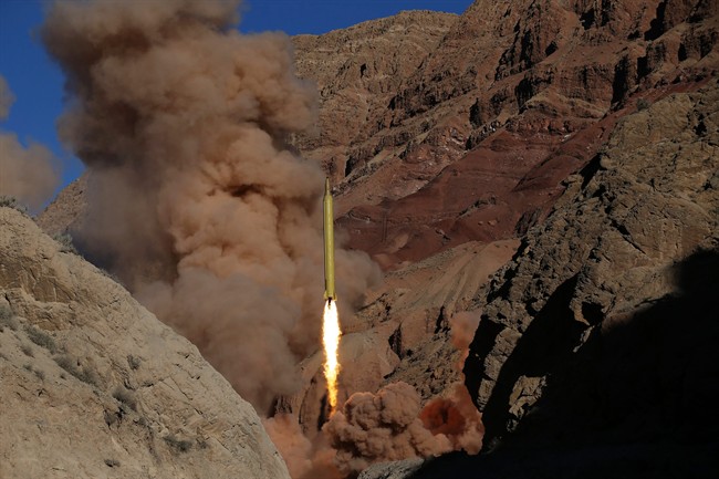 In this photo obtained from the Iranian Fars News Agency, a long-range ballistic missile is fired by Iran's powerful Revolutionary Guard in an undisclosed location, Wednesday, March 9, 2016. AP Photo/Fars News Agency, Omid Vahabzadeh.