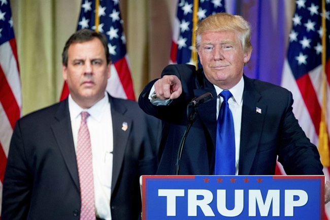Republican presidential candidate Donald Trump, accompanied by New Jersey Gov. Chris Christie, left, takes questions from members of the media during a news conference on Super Tuesday primary election night in the White and Gold Ballroom at The Mar-A-Lago Club in Palm Beach, Fla., Tuesday, March 1, 2016.