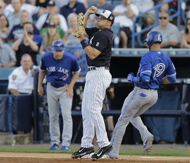New York Yankees first baseman Mark Teixeira reacts as he gets out of the way after getting Toronto Blue Jays' Jose Bautista out at first base during the first inning of a spring training baseball game, Wednesday, March 16, 2016, in Tampa, Fla.