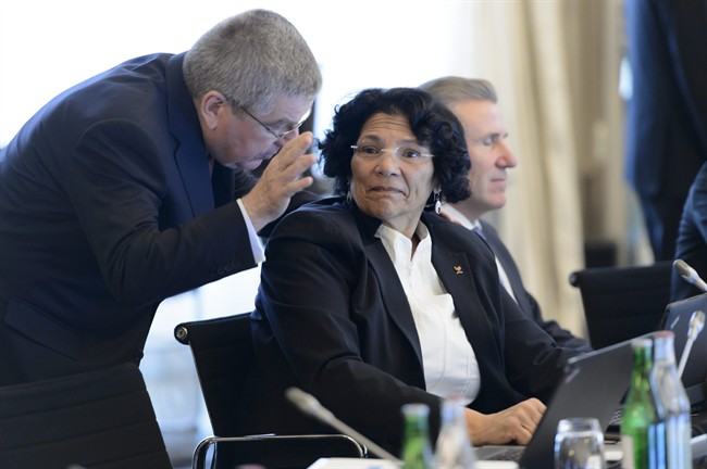 International Olympic Committee (IOC) president Thomas Bach, of Germany, left, speaks with Member of the International Olympic Committee, IOC, Anita DeFrantz, of the US, right, at the opening of the second and last day of the executive board meeting of the International Olympic Committee (IOC), in Lausanne, Switzerland.