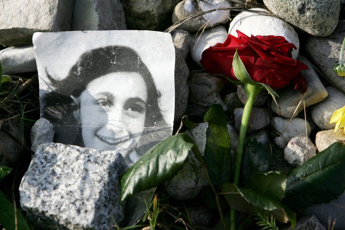 A picture of Anne Frank lies in front of the memorial stone for Jewish girl Anne Frank, author of "The Diary of a Young Girl", and her sister Margot, 28 October 2007 on the grounds of the new Bergen-Belsen Memorial. 