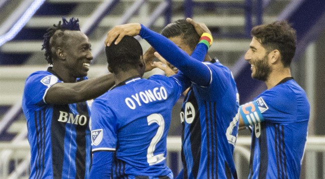 Montreal Impact's Dominic Oduro, left, celebrates with teammates after scoring against the New York Red Bulls during second half MLS soccer action in Montreal Saturday, March 12, 2016.