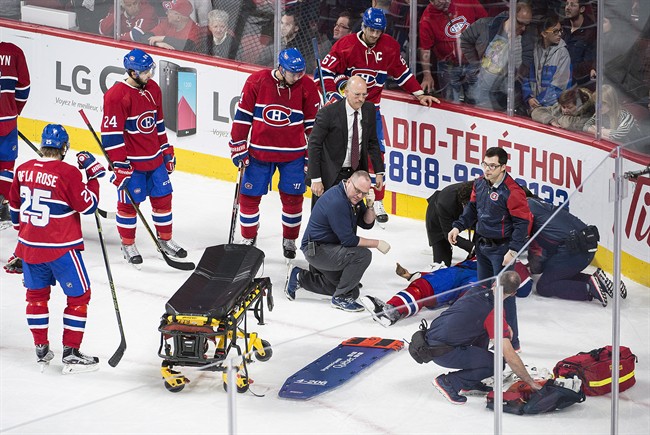 Montreal Canadiens players look on as teammate P.K. Subban lies injured on the ice during third period NHL hockey action against the Buffalo Sabres in Montreal, Thursday, March 10, 2016.