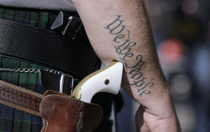 Scott Smith, a supporter of open carry gun laws, wears a pistol as he prepares for a rally in support of open carry gun laws at the Capitol, in Austin, Texas.  (File photo) .