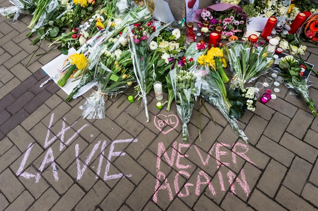 A makeshift memorial near the entrance of metro station Maelbeek in Brussels, Belgium, Thursday, March 24, 2016. 