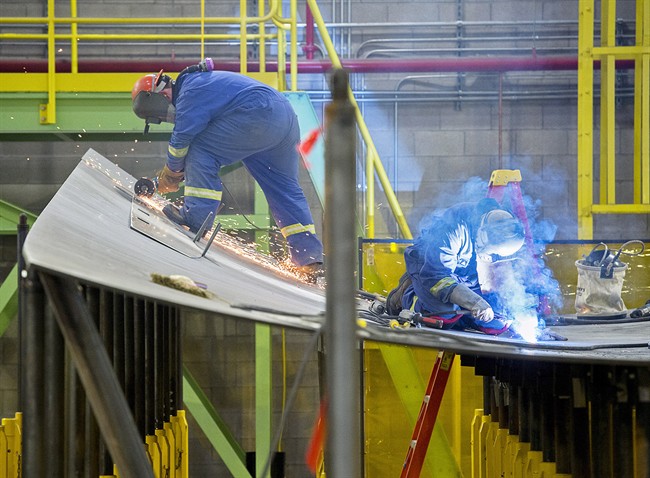 Workers construct components of the Arctic offshore patrol ships at the Irving shipbuilding facility in this file photo in Halifax on Friday, March 4, 2016. The chosen designs to replace the navy's warship fleet will be constructed by Irving.