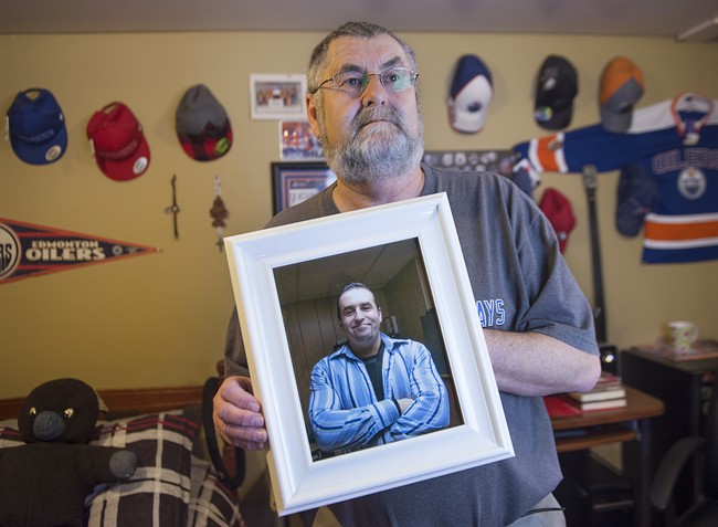 Ernie LeBlanc hold a photo of his son Jason LeBlanc at their home in Sydney Mines, N.s. on Monday, March 14, 2016.