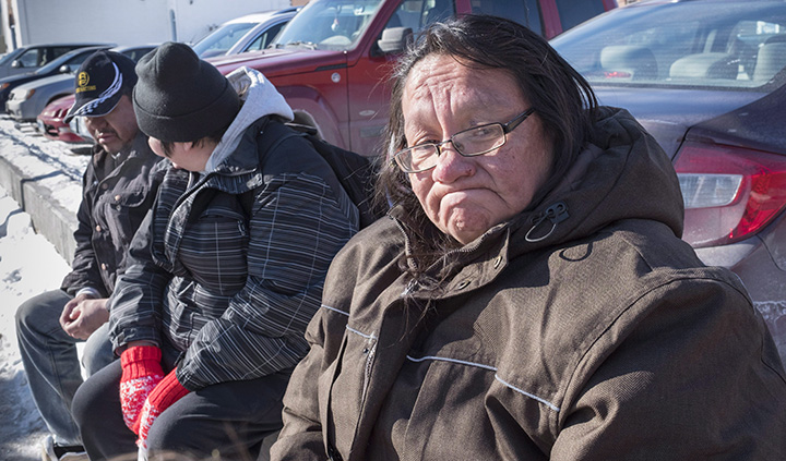 Bessie Strang pauses as she tells her story while sitting with other homeless friends, Friday, March 4, 2016 in Thunder Bay, Ont. 