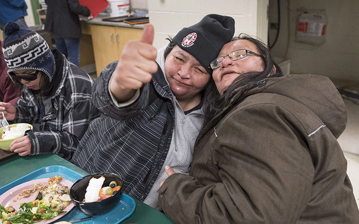 Bessie Strang hugs a homeless friend during dinner at the Shelter House, Friday, March 4, 2016 in Thunder Bay, Ont.