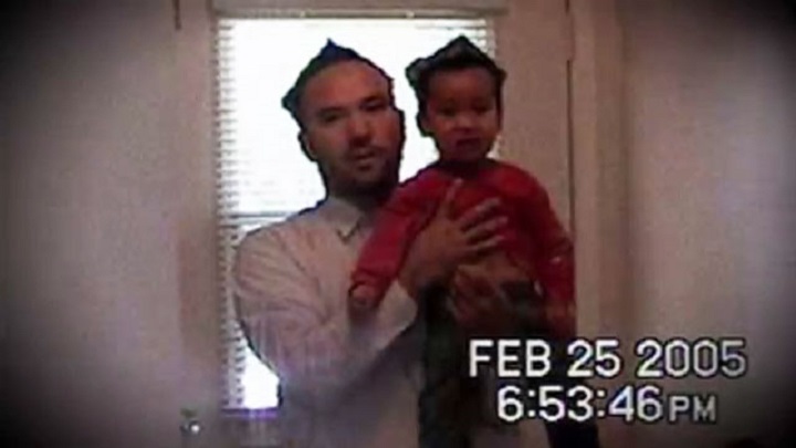 Huseyin Celil is seen in this photo holding his son in their Burlington, Ont. home on Feb, 25, 2005.