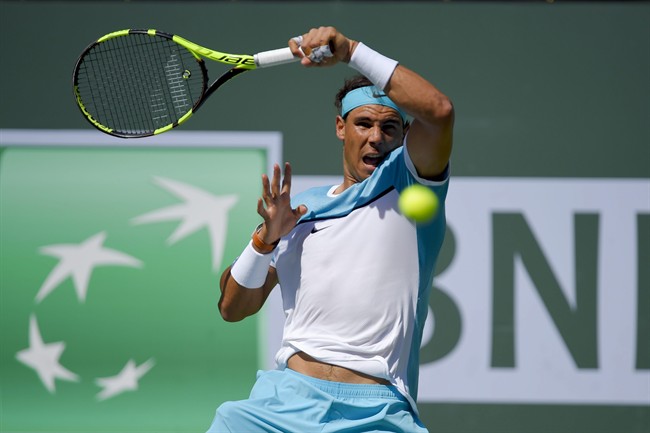 Rafael Nadal, of Spain, returns to Novak Djokovic, of Serbia, during their semifinal match at the BNP Paribas Open tennis tournament, Saturday, March 19, 2016, in Indian Wells, Calif.