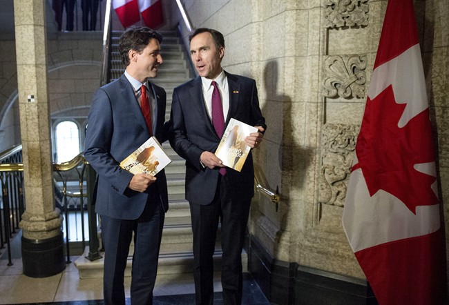 Prime Minister Justin Trudeau (left) speaks with Minister of Finance Bill Morneau as he arrives to table the budget on Parliament Hill, Tuesday, March 22, 2016, in Ottawa.