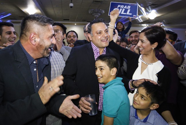 Prab Gill, centre left, celebrates his byelection win in the Calgary Greenway riding in Calgary on Tuesday, March 22, 2016.