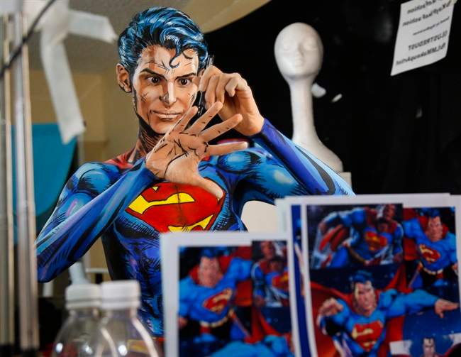 Over a 12 hour period, all the while live streaming on the internet, Kay Pike transforms herself using body paint and latex into Superman at her home in Calgary, Alta., Saturday, March 19, 2016.