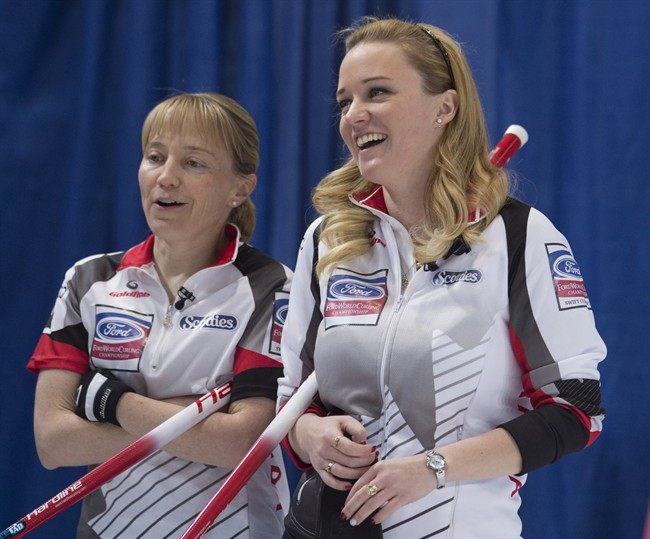 Canadian skip Chelsea Carey, right, shares a laugh with third Amy Nixon during the 9th draw against Germany at the Women's World Curling Championship in Swift Current, Sask. Tuesday, March 22, 2016. THE CANADIAN PRESS/Jonathan Hayward