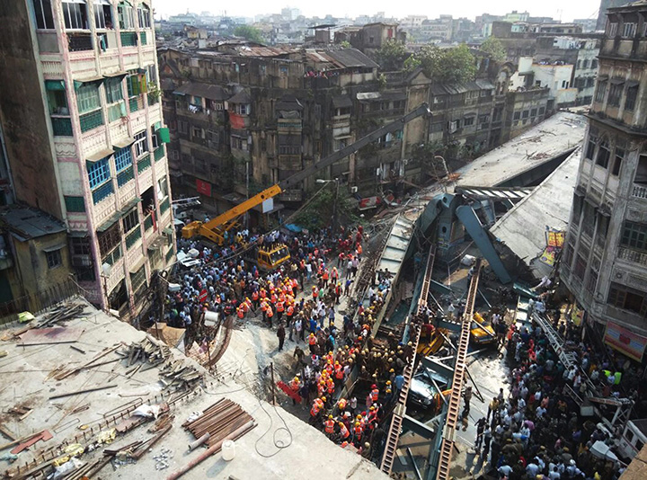 Locals and rescue workers clear the rubble of a partially collapsed overpass in Kolkata, Thursday, March 31, 2016.