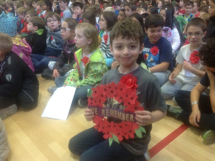 George Levantis Athanasios, 7, holds his artwork, which was sent as part of a Remembrance Day care-package to the Prime Minister's office, Wednesday, November 11, 2015.